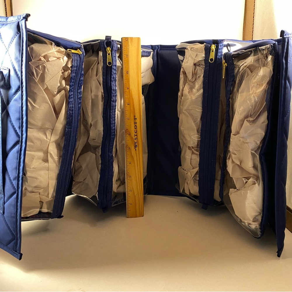 Never used Joy Mangano Large Roll up beauty/toiletries/accessories case.